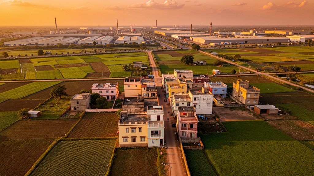 Aerial panoramic view of Sanand town Gujarat with agricultural fields and industrial area at golden hour